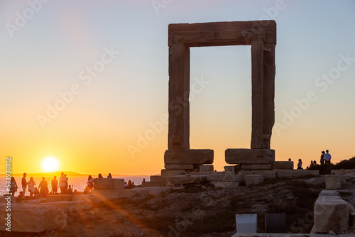Naxos island, sunset over Temple of Apollo, Cyclades Greece. People admires the sundown background.