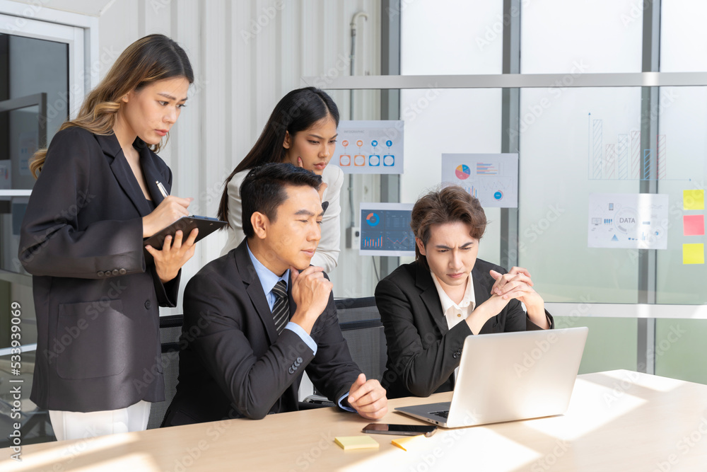 A group of young Asian businessmen Talking and planning work happily and have fun. at the company's office A group of young Asian businessmen Talking and planning work happily and have fun. at the company's office