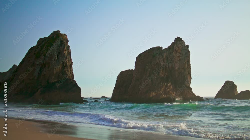 Rocky cliffs rising ocean surface on Portugal Ursa beach summer evening. Rocky cliffs rising ocean surface on Portugal Ursa beach summer evening.
