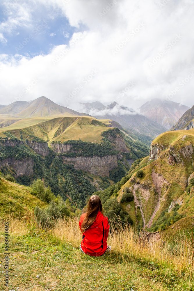 Panorama of the Caucasus Mountains in Georgia, viewed by a woman
