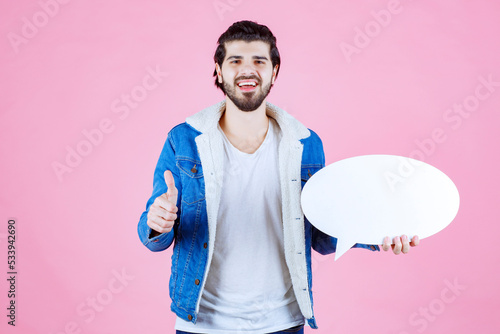 Man holding a blank ideapad and showing thumb up photo