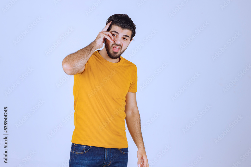 Man in yellow shirt standing neutral without reaction Man in yellow shirt standing neutral without reaction