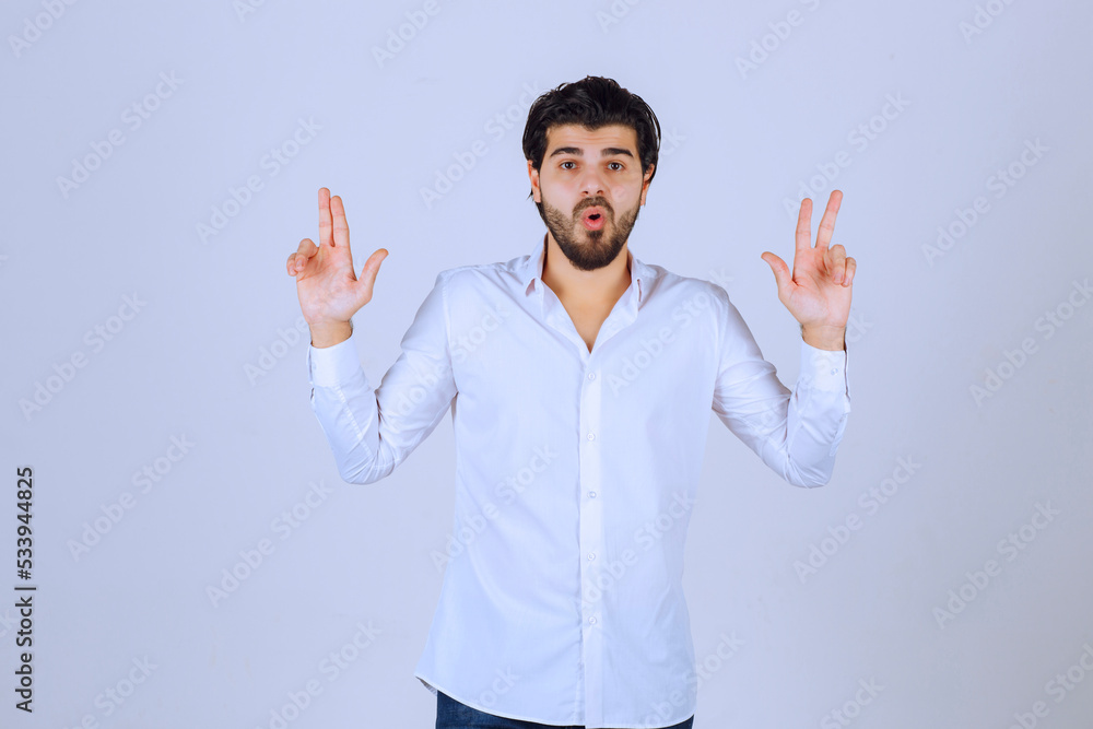Man showing peace and friendship sign Man showing peace and friendship sign