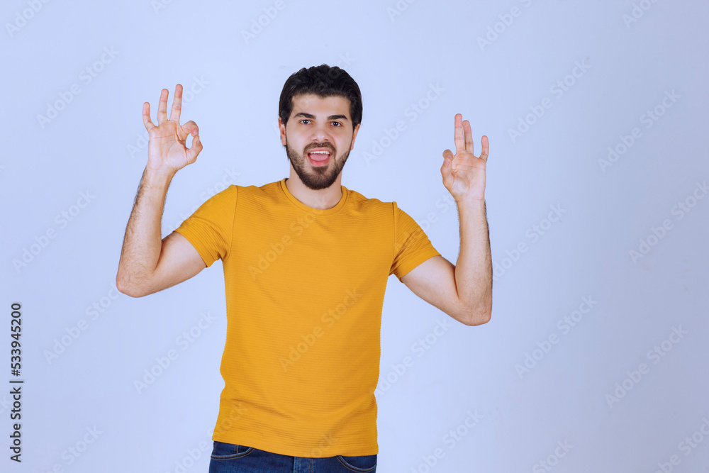 Man showing enjoyment and ok hand sign Man showing enjoyment and ok hand sign