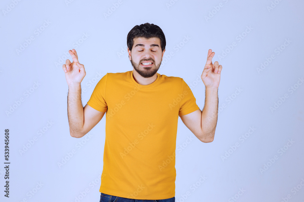 Man showing cross sign in the hand