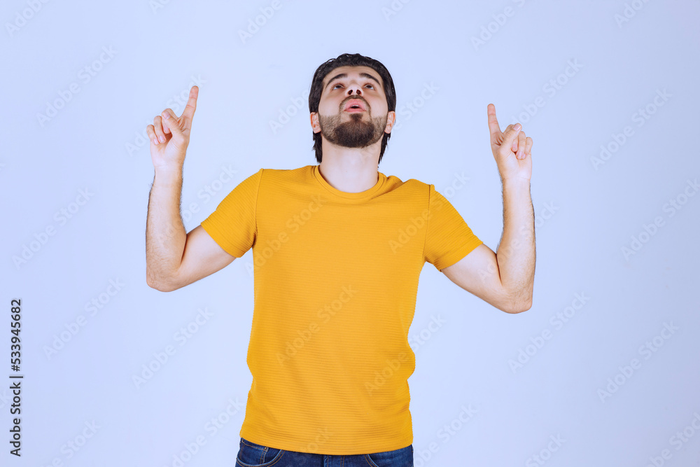 Fototapeta premium Man pointing up and demonstrating something