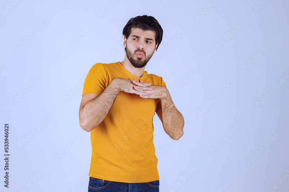Man in yellow shirt giving seductive and appealing poses Man in yellow shirt giving seductive and appealing poses