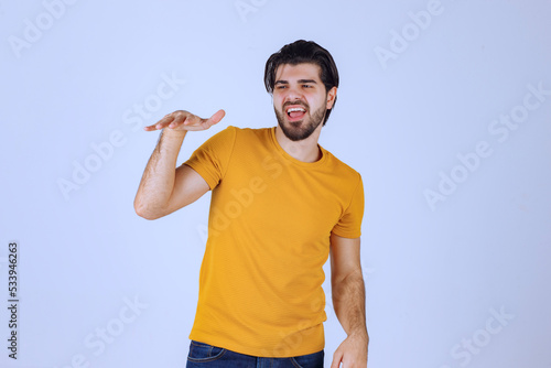 Man in yellow shirt giving seductive and appealing poses