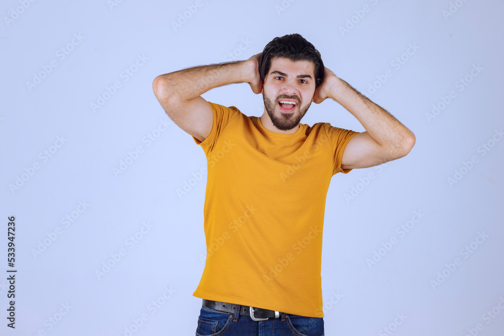 Man with beard putting hands back to his head and smiling Man with beard putting hands back to his head and smiling