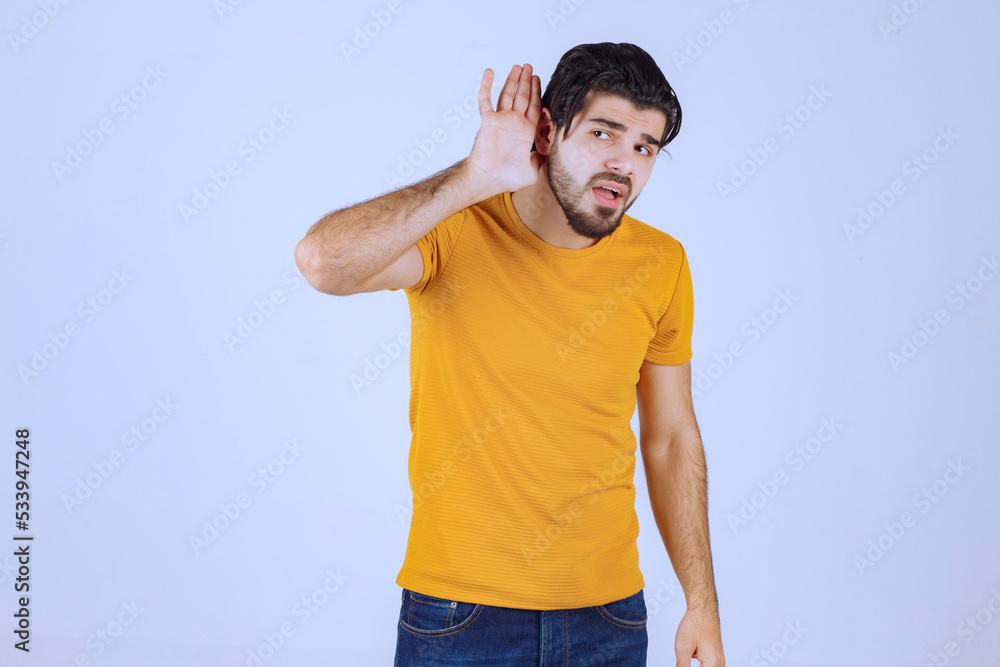Man with beard showing his hear and trying to listen attentively Man with beard showing his hear and trying to listen attentively