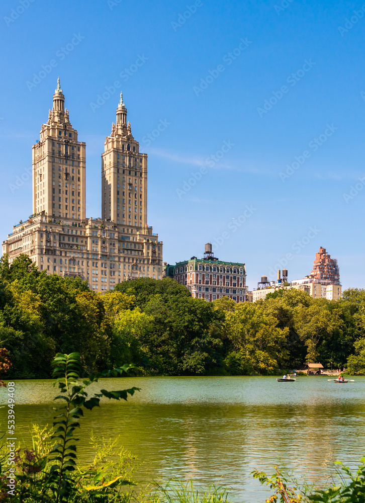 Lake with boats in Central Park in midtown Manhattan in New York City with Eldorado building