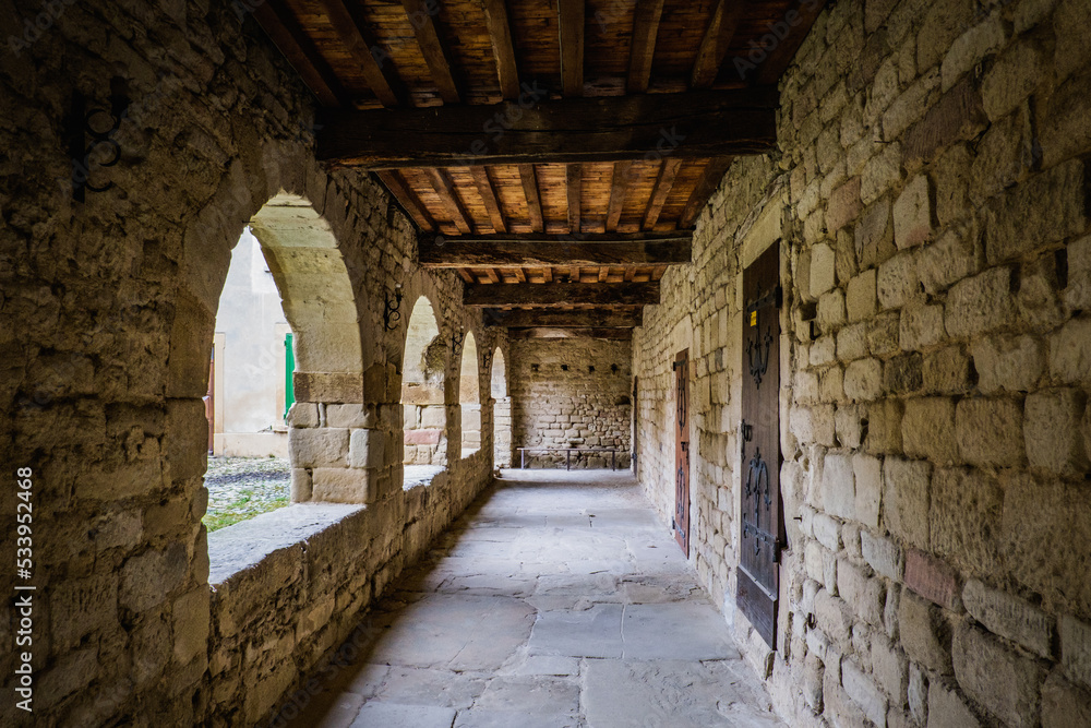 Obraz premium The covered archways of the medieval cloister of Saint Agnes priory in Saint Jean de Galaure (Drome, France)