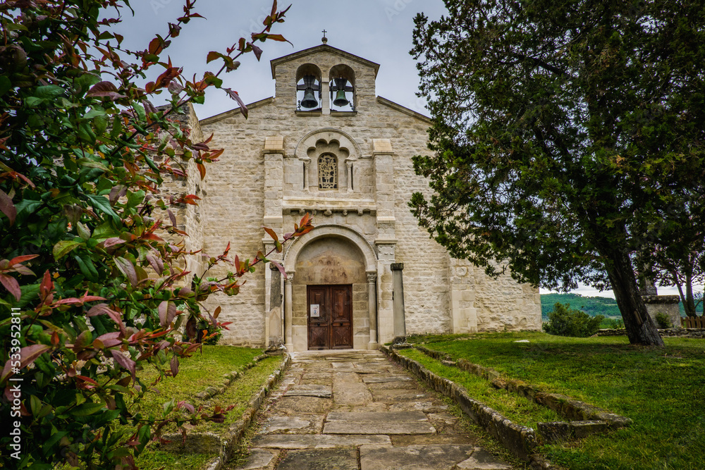  View on the romanesque facade of the Saint Agnes church in Saint Jean de Galaure (Ardeche, France)