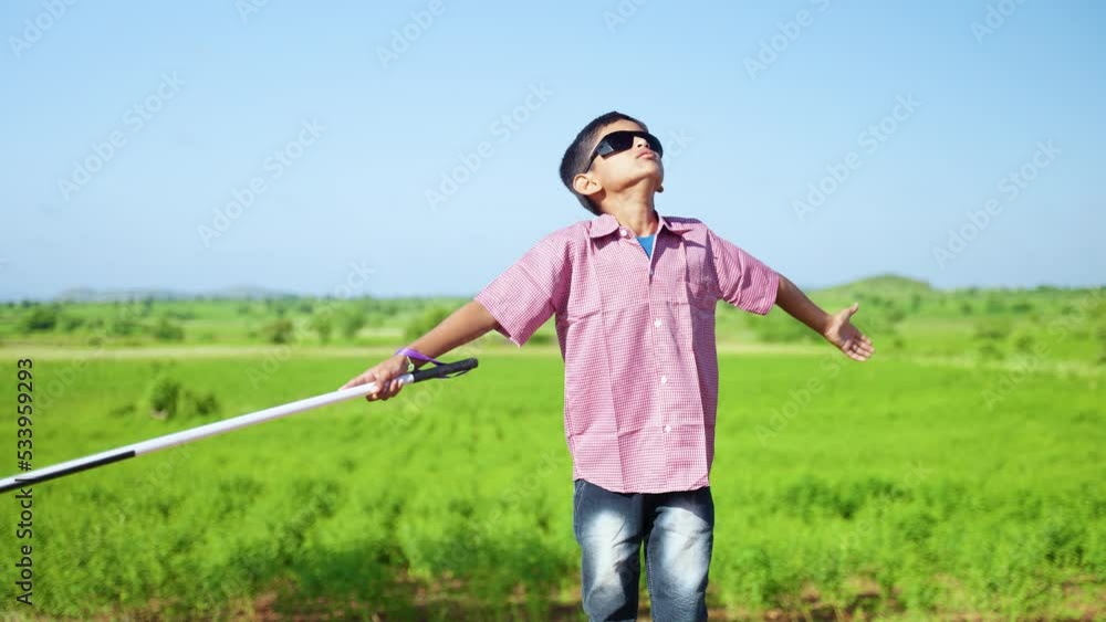 indian teeneger blind kid with eyeglasses enjoying nature and fresh air at freetime on mountain - concept of freedom, healthy lifestyle and wellness. indian teeneger blind kid with eyeglasses enjoying nature and fresh air at freetime on mountain - concept of freedom, healthy lifestyle and wellness.