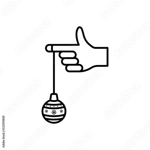 Icono de bola navideña colgando del dedo de la mano. Ilustración vectorial