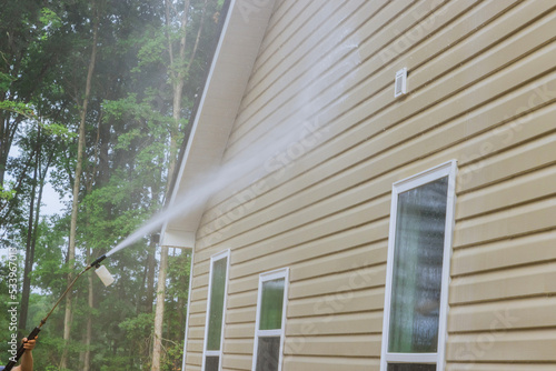 Cleaning maintenance service for washing siding house and maintaining the home a high-pressure spray nozzle with soap cleaner and water