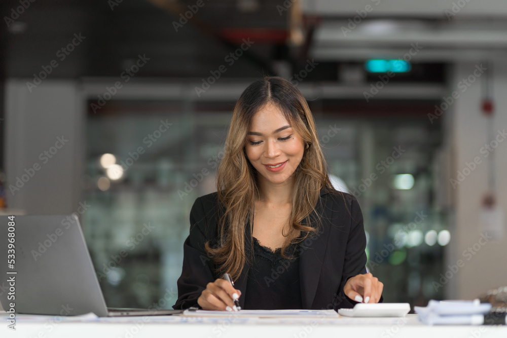 Confident asian businesswoman working in office workstation. Confident asian businesswoman working in office workstation.