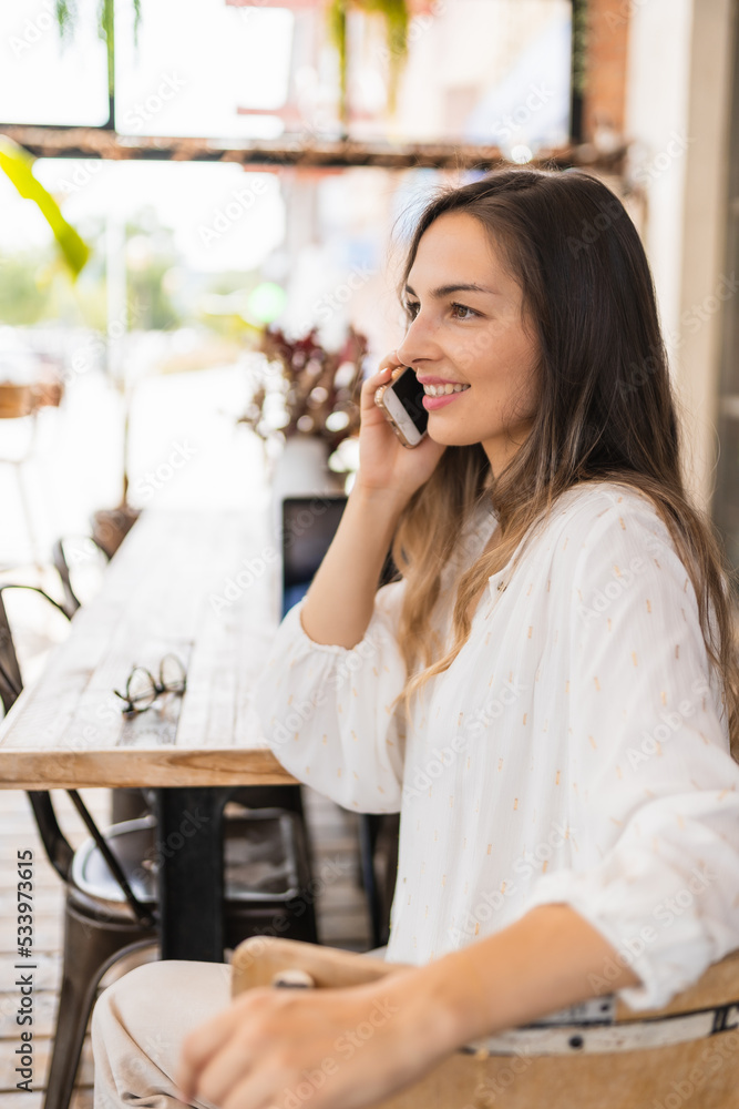Cheerful businesswoman speaking on smartphone on terrace Cheerful businesswoman speaking on smartphone on terrace