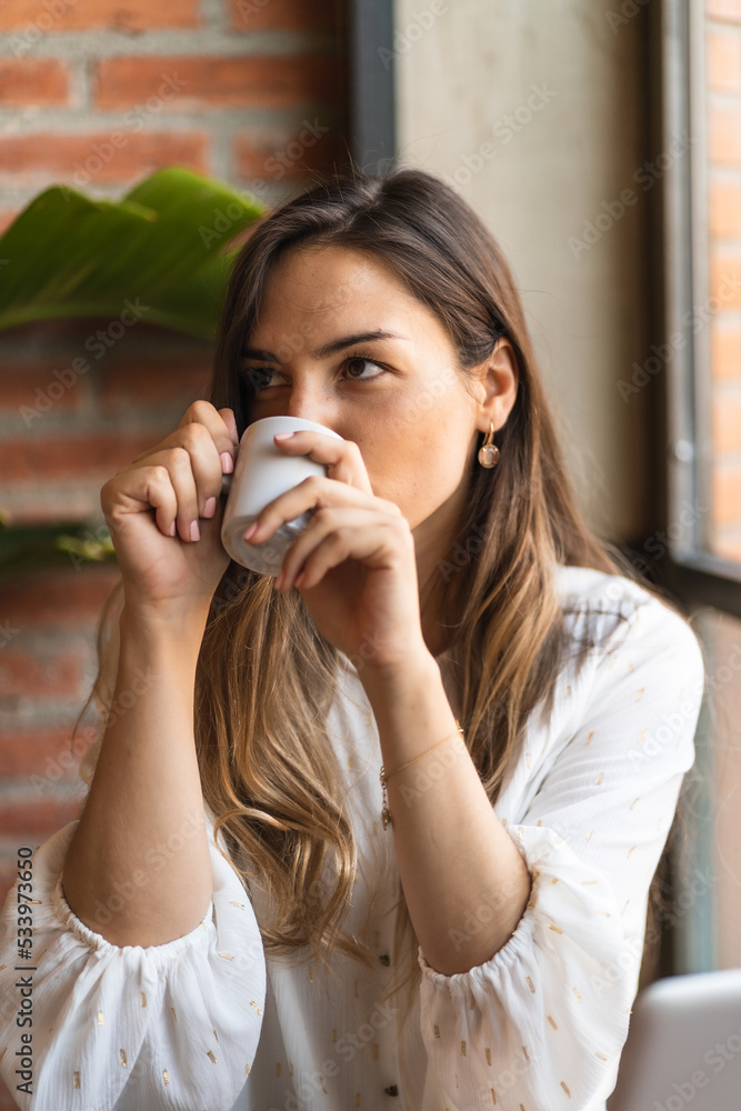 Female freelancer drinking coffee in cafe Female freelancer drinking coffee in cafe
