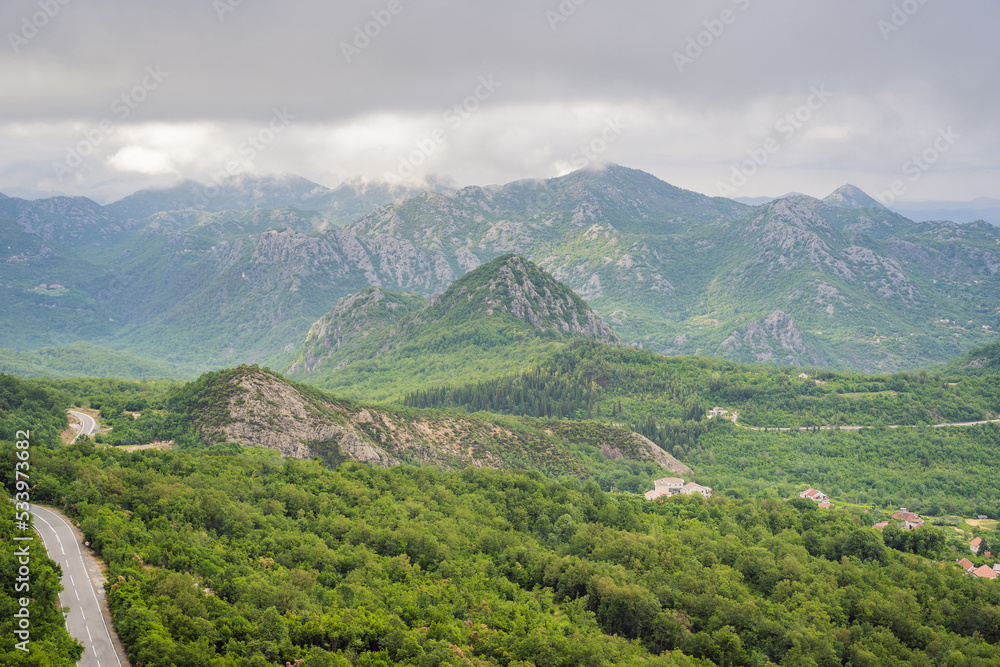 Beautiful view of the mountains of Montenegro and Skadar lake Portrait of a disgruntled girl sitting at a cafe table