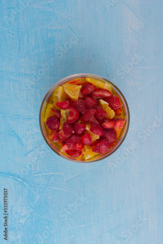 Fruit salad with strawberry and oranges, top view