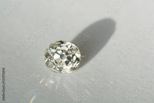 Antique vintage white old days diamond loose stone setting with polished culet. Transparent precious natural cushion faceted European cut gemstone. Hardness 10. White paper background. Daylight sparkl