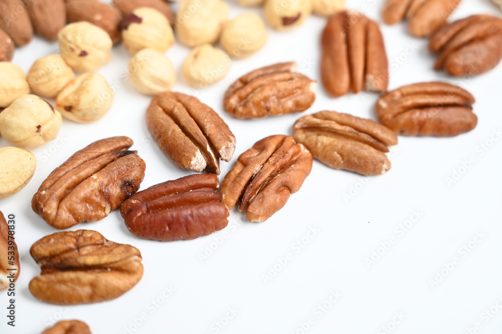 Pecan nut and other nut isolated on white background with copy space. Pecan nut and other nut isolated on white background with copy space.