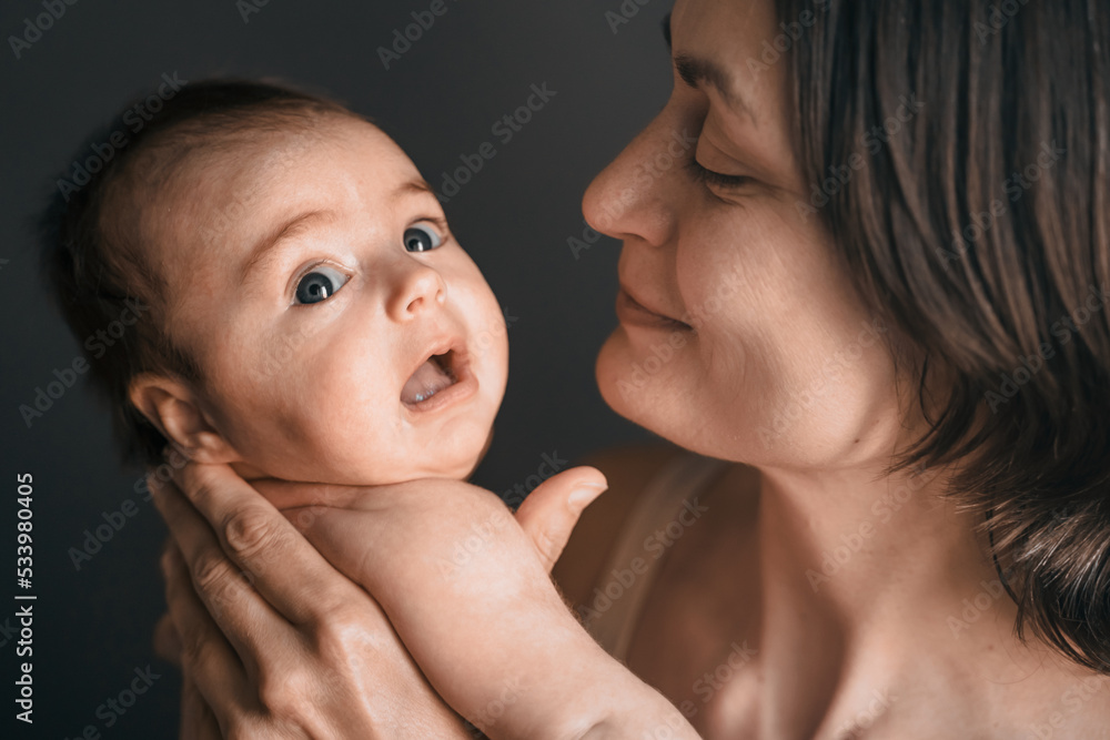 Mom, mummy, young mother with little baby daughter. Breast-feeding. Mum kissing,hugging child. Newborn cute happy girl smiling in woman hands. Family happiness. Age parents, parenting, motherhood Mom, mummy, young mother with little baby daughter. Breast-feeding. Mum kissing,hugging child. Newborn cute happy girl smiling in woman hands. Family happiness. Age parents, parenting, motherhood