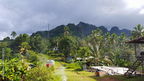 A remote village community in the hills of Arawa in central Bougainville Island, Papua New Guinea, surrounded by lush, green trees in the jungle photo