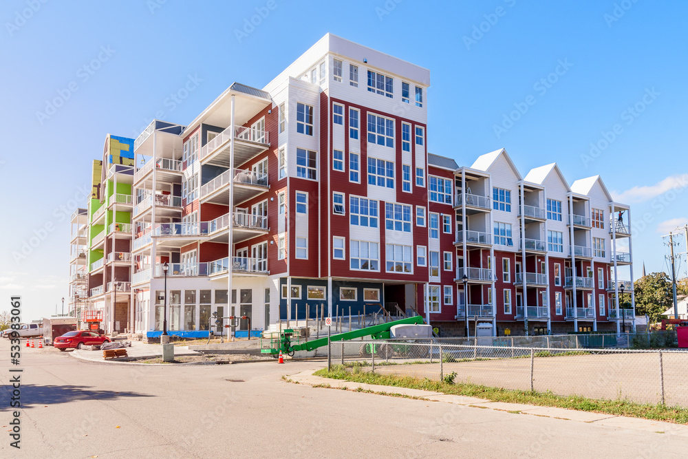 New apartment building in construction on a sunny autumn day New apartment building in construction on a sunny autumn day