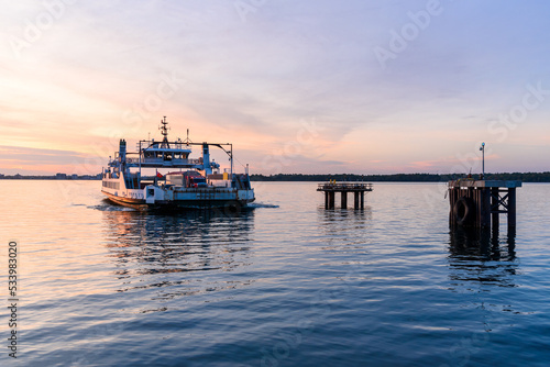Ferry arriving at the terminal at sunset