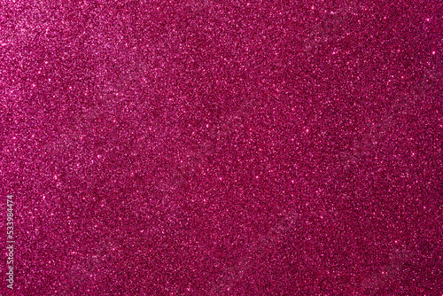 Background with sparkles. Backdrop with glitter. Shiny textured surface. Dark pink