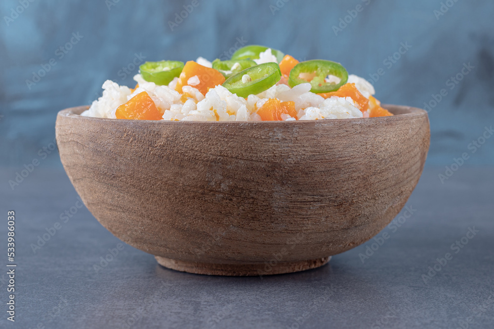 Rice with pepper and carrots, on the marble background Rice with pepper and carrots, on the marble background