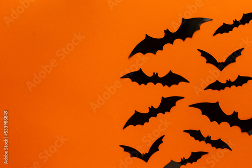 halloween orange background with bats on the right side