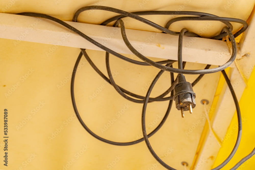 Black tangled electrical cable connecting lights and other electrical appliances. Black tangled electrical cable connecting lights and other electrical appliances.