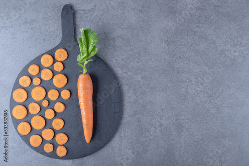Carrots picked in the garden, on the cutting board , on the marble background photo