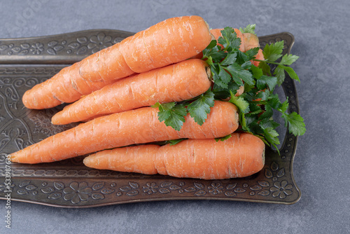 A tray of carrot and greens vegetable , on the marble background