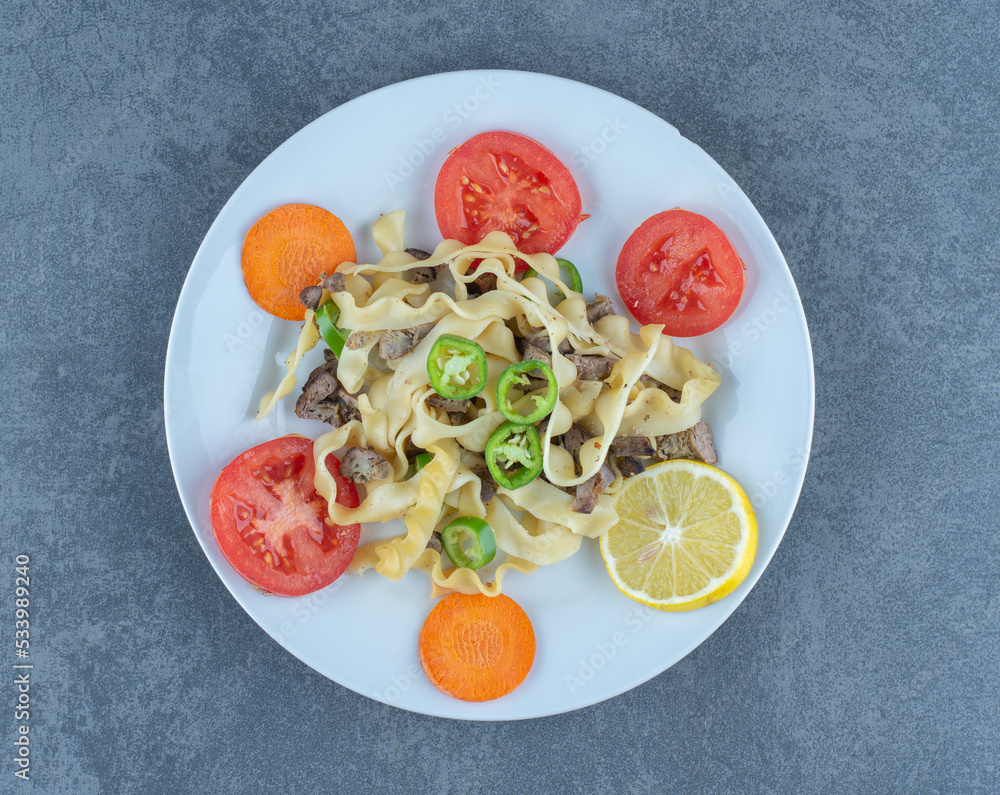 Delicious pasta with vegetables on white plate