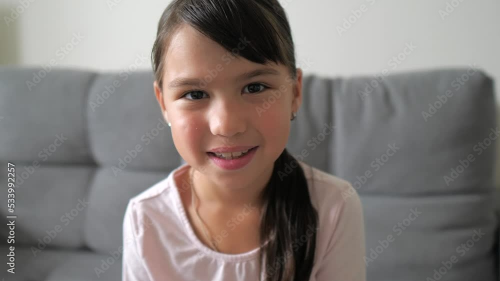 Close up portrait of caucasian little brunette girl in pink shirt smiling look at camera at home. Adorable kid smile with teeth. Happy childhood concept. Close up portrait of caucasian little brunette girl in pink shirt smiling look at camera at home. Adorable kid smile with teeth. Happy childhood concept.
