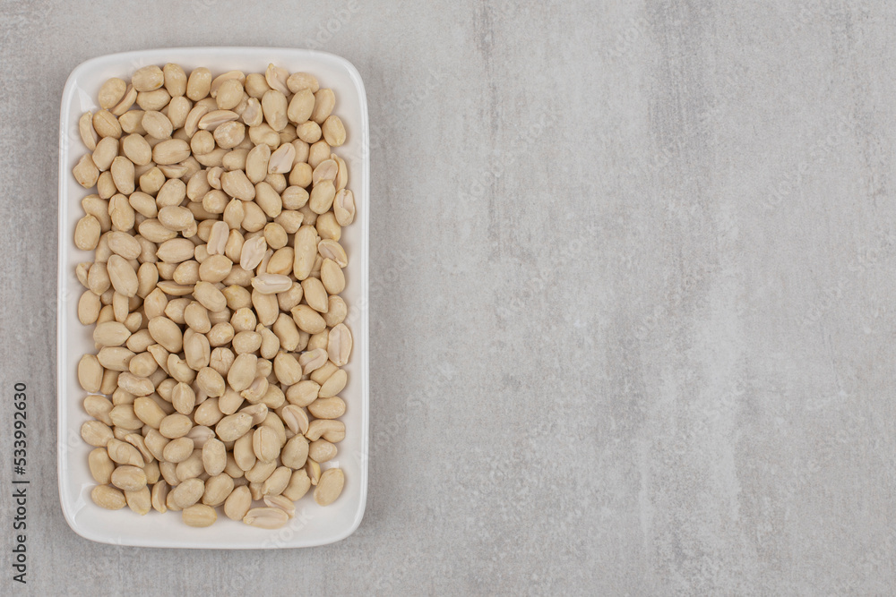 Bunch of peeled peanuts on white plate Bunch of peeled peanuts on white plate