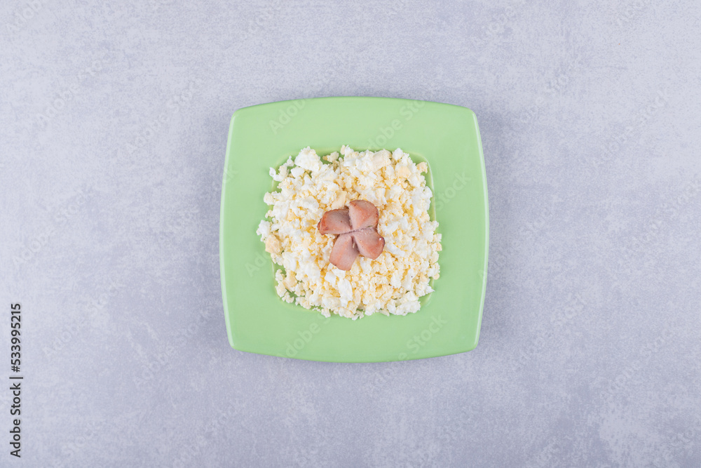Fried sausages and macaroni on green plate Fried sausages and macaroni on green plate