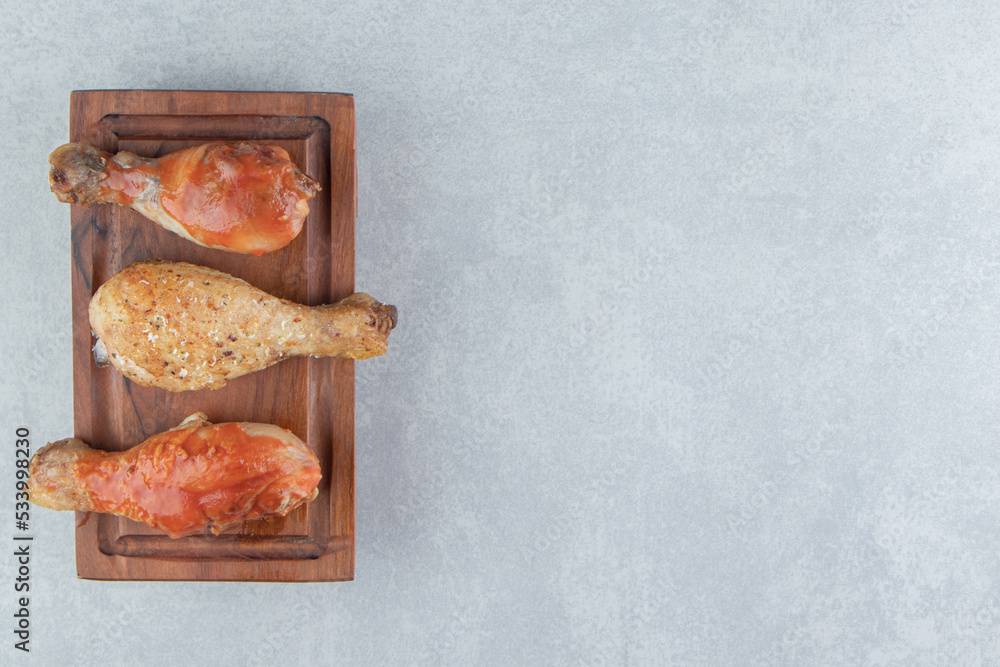 A wooden board with fried delicious chicken meat A wooden board with fried delicious chicken meat