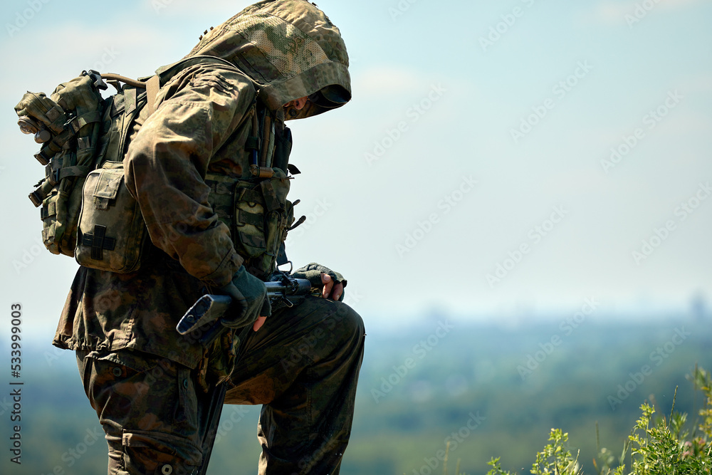 Fototapeta premium Full military experience - One day commando - running through the water with automatic rifle replica