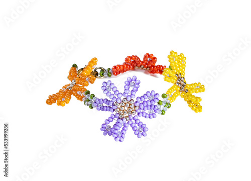 Women's bracelet, woven of lilac, red and yellow beads. Isolated on white.