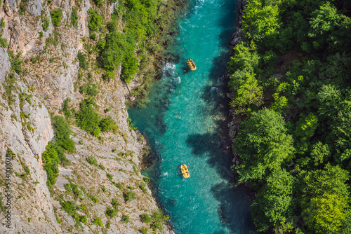 Famous rafting and kayaking place. Active kayakers in colorful life jacket paddling and exercising. Rafting on the turquoise river. Montenegro natural landscape, mountain river Tara