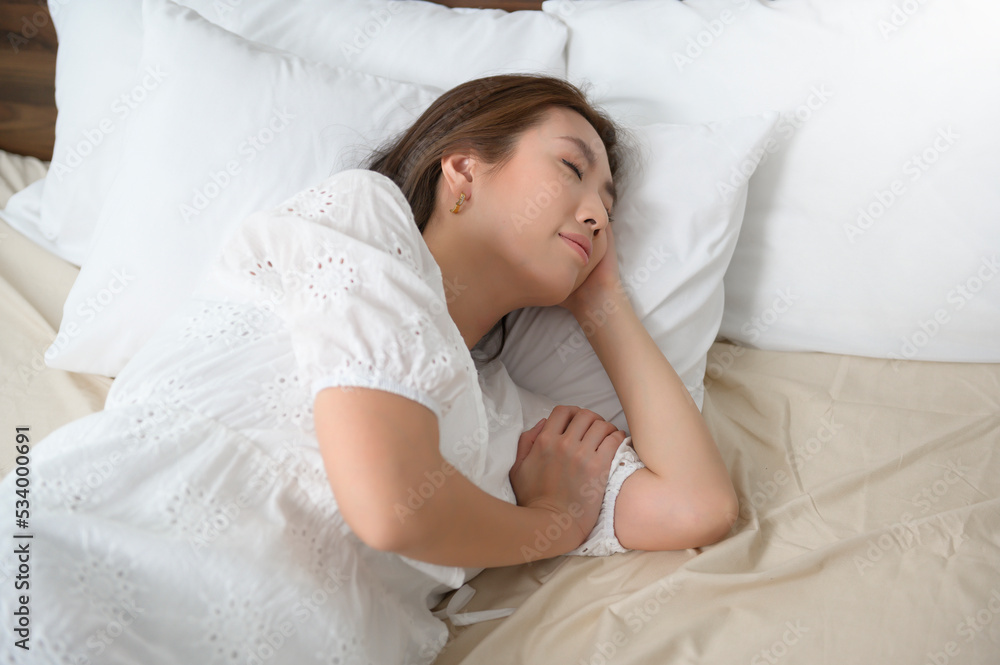 young asian woman sleeping on the bed in bedroom, happy healthy lifestyle concept young asian woman sleeping on the bed in bedroom, happy healthy lifestyle concept
