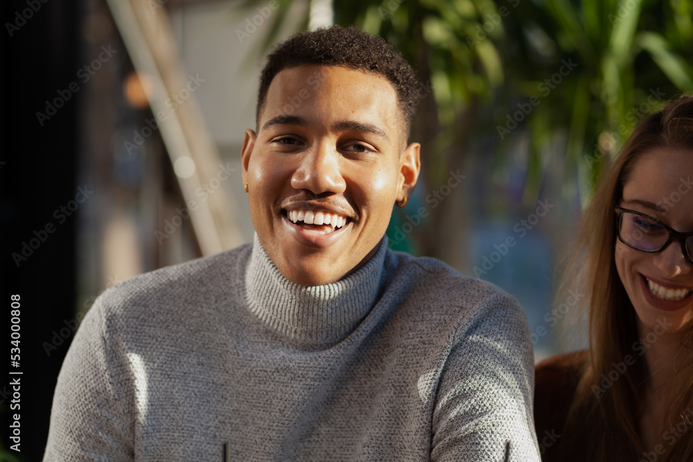 Two multiracial friends smiling in a bar. Afterwork meeting after successful work day. Two multiracial friends smiling in a bar. Afterwork meeting after successful work day.