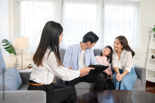 Asian family meeting with female real estate agent or insurance consultant offering promotions , Mortgage, loan, property and medical health insurance concept.