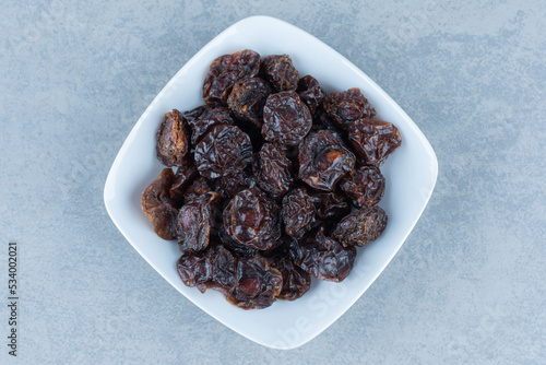 A bowl of dried cherry, on the marble background