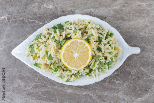 Toothsome pasta with green vegetables , on the marble background